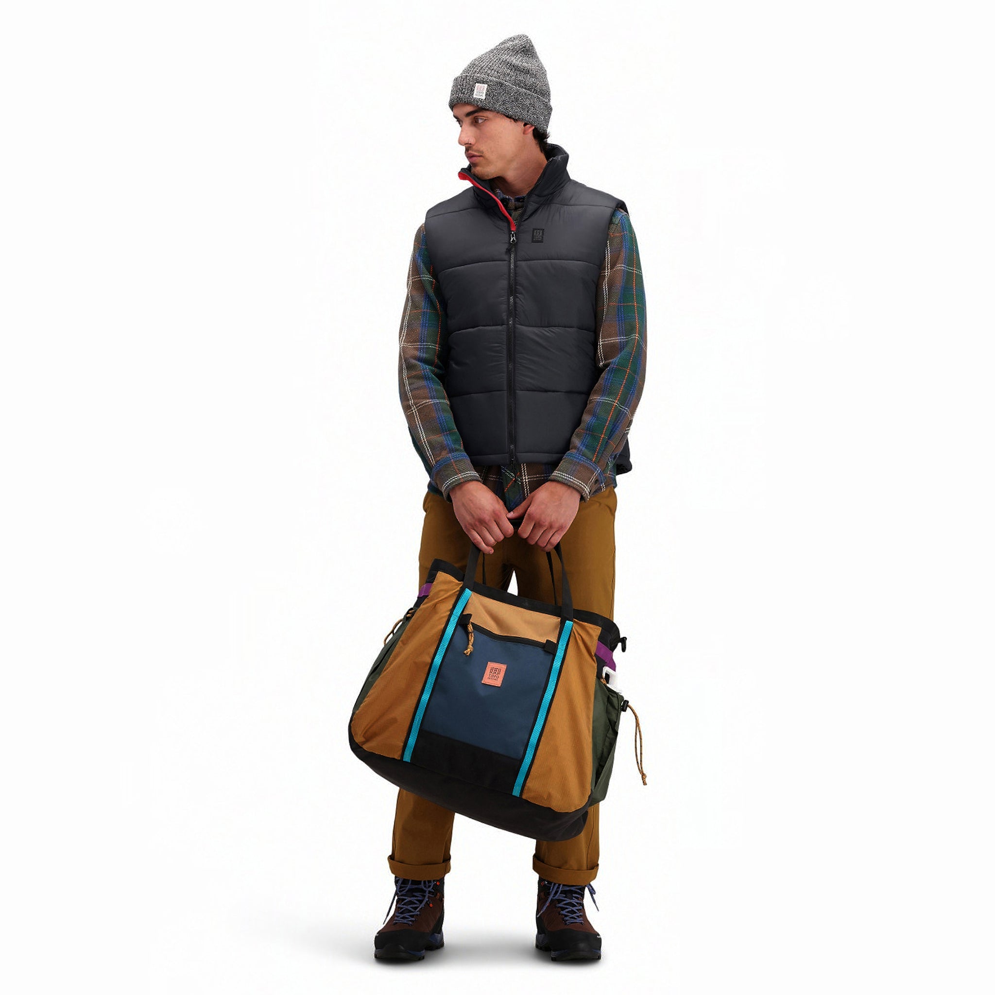 Front model shot of Topo Designs Men's Mountain Puffer recycled insulated Vest in "Black".