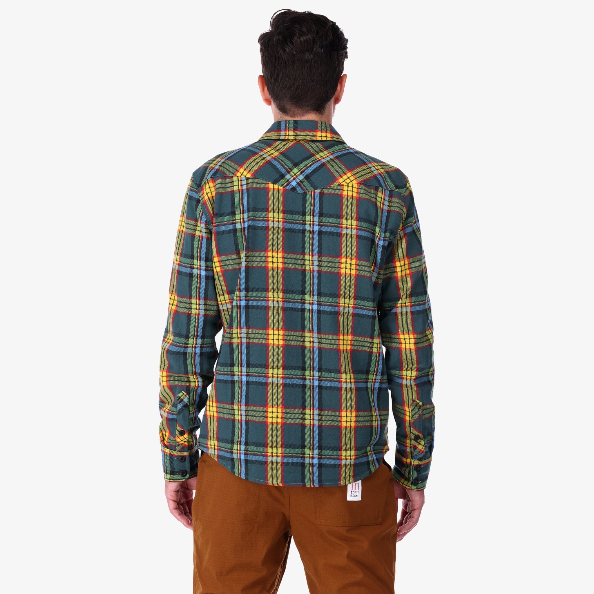 Back of Topo Designs men's mountain organic cotton flannel shirt in "green multi" plaid on model.