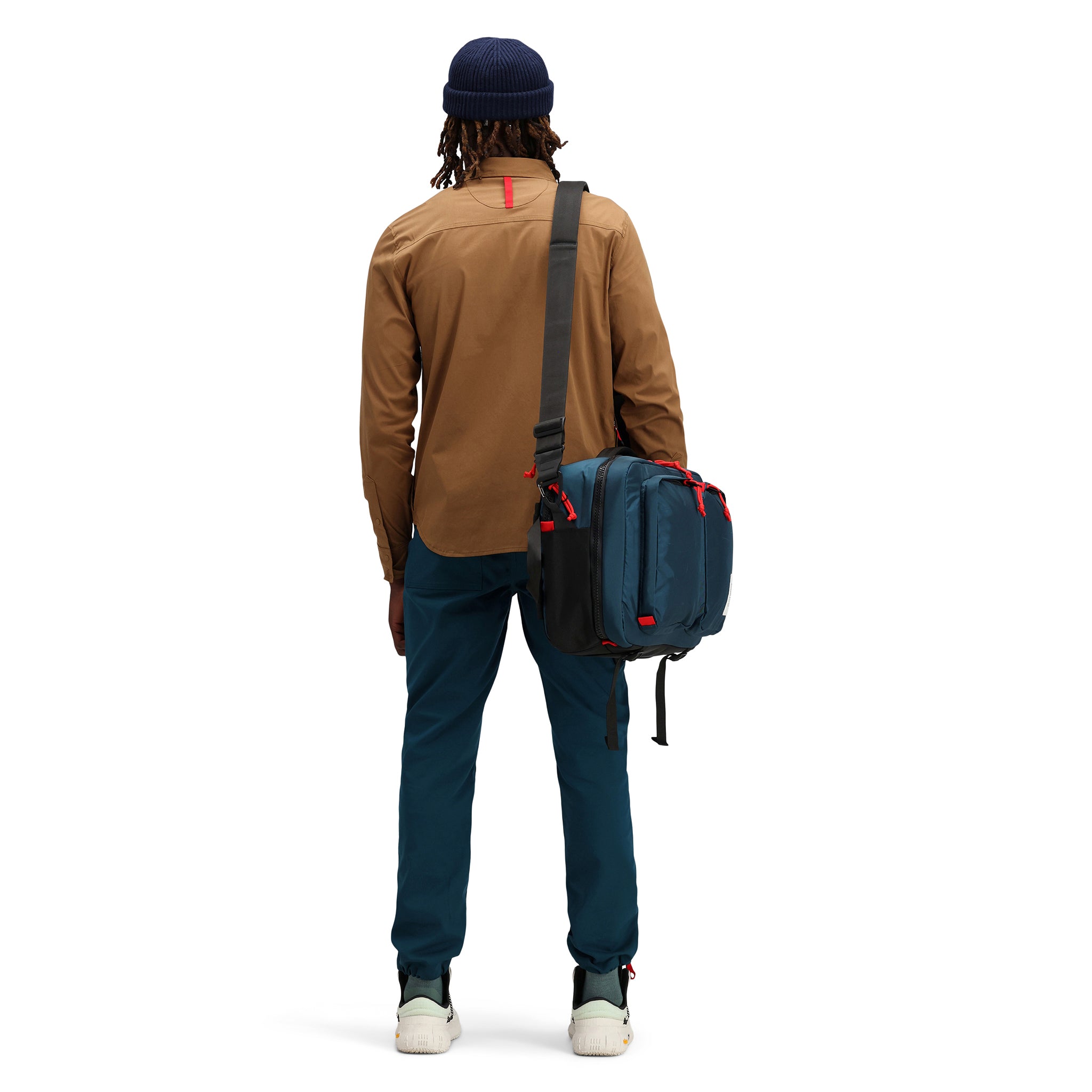 Back model shot of Topo Designs Men's Global Shirt long sleeve lightweight travel snap shirt in "Dark Khaki" brown.