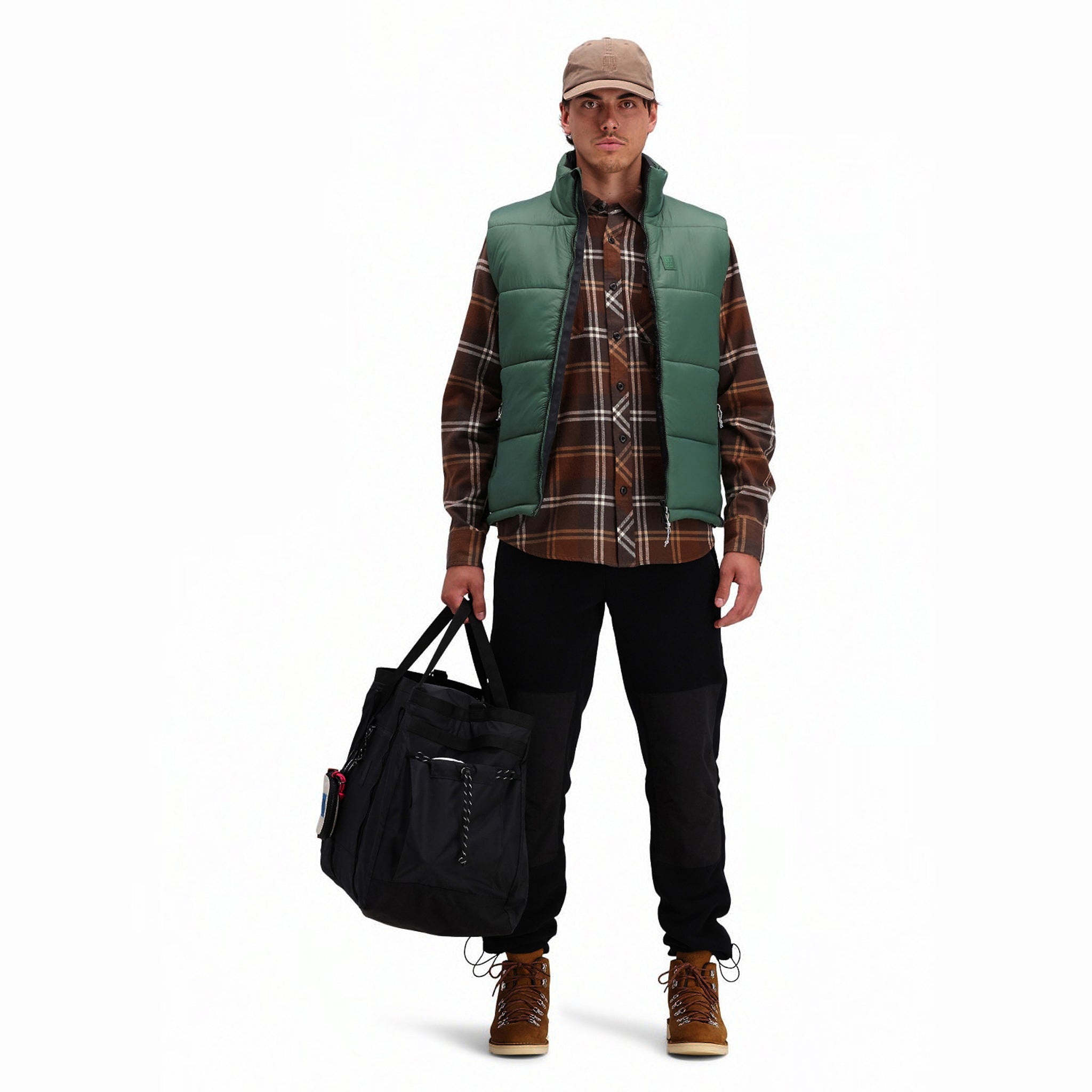 Front model shot of Topo Designs men's mountain organic cotton flannel shirt in "earth / tan plaid" brown