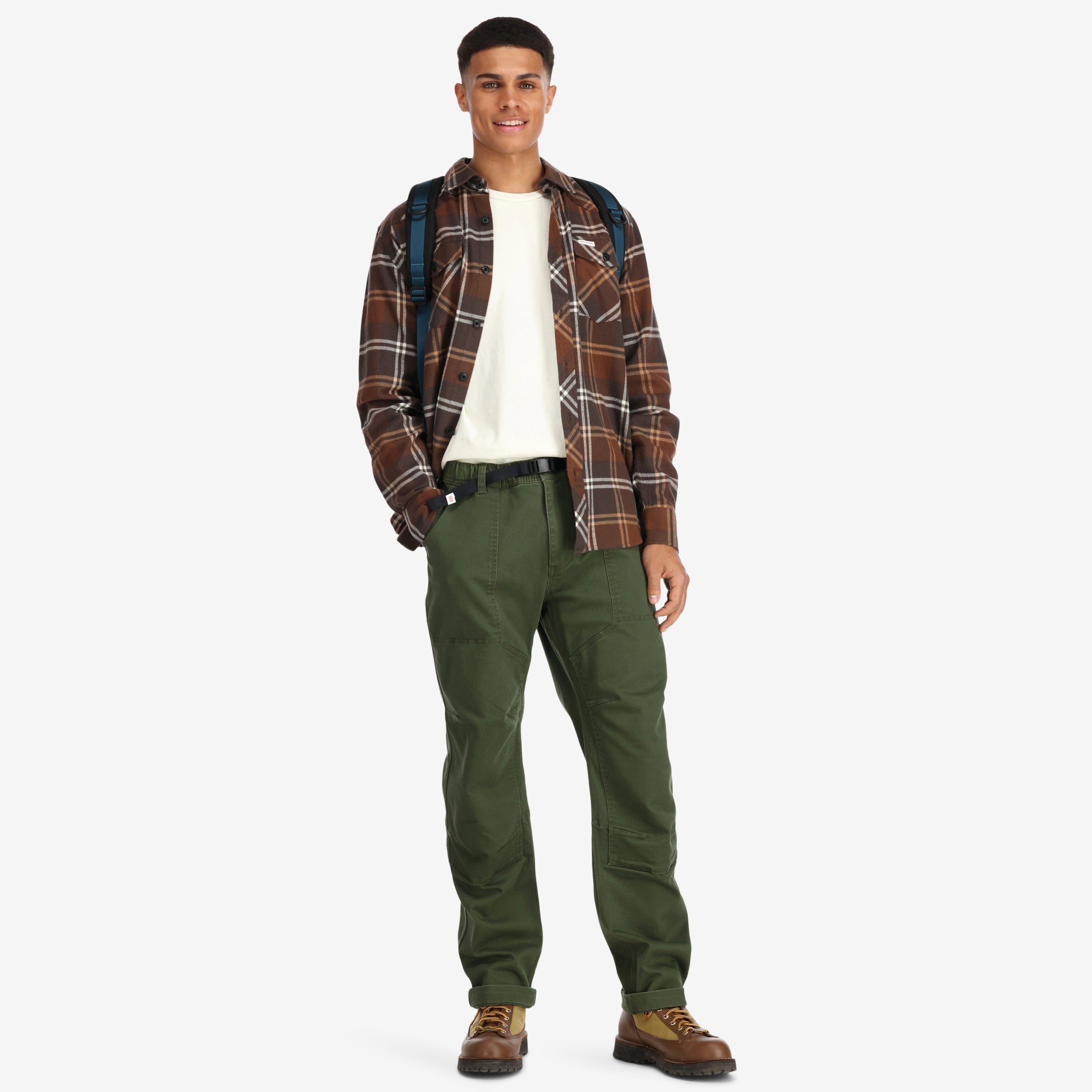 Front model shot of Topo Designs men's mountain organic cotton flannel shirt in "earth / tan plaid" brown