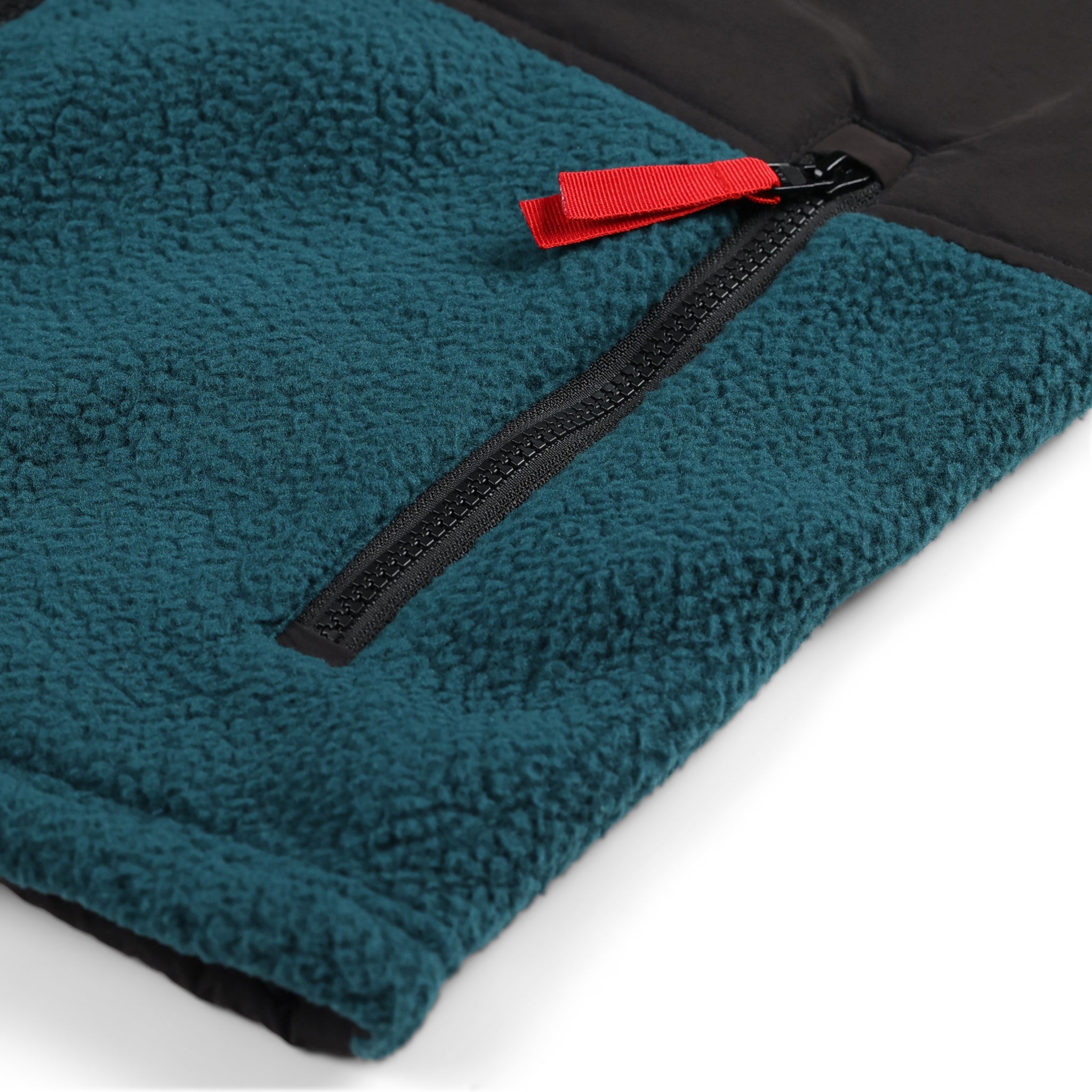 General detail product shot of the men's subalpine fleece in pond blue/black showing zipper pocket.