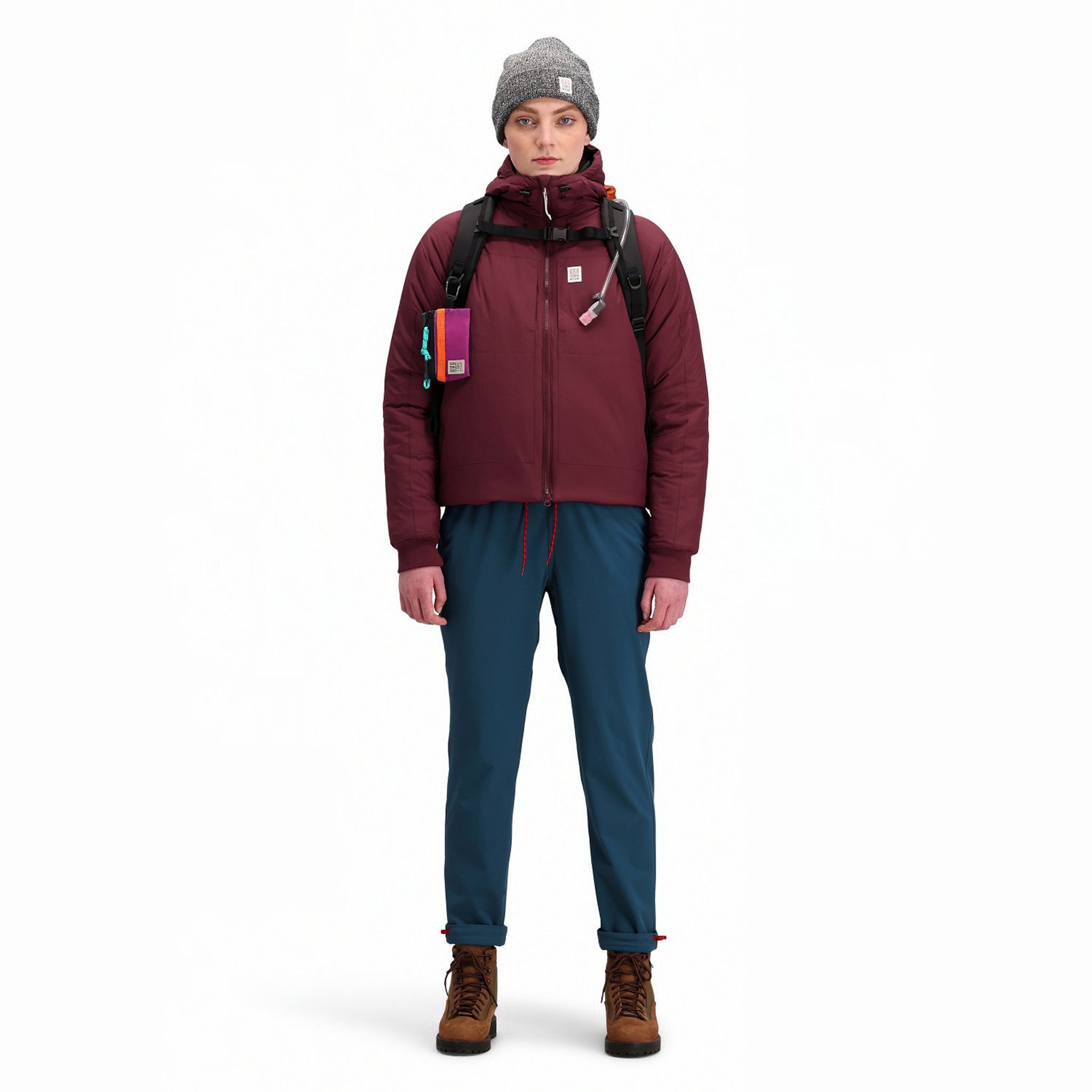 Front model shot of Topo Designs Women's Puffer Primaloft insulated Hoodie jacket in "burgundy" red.