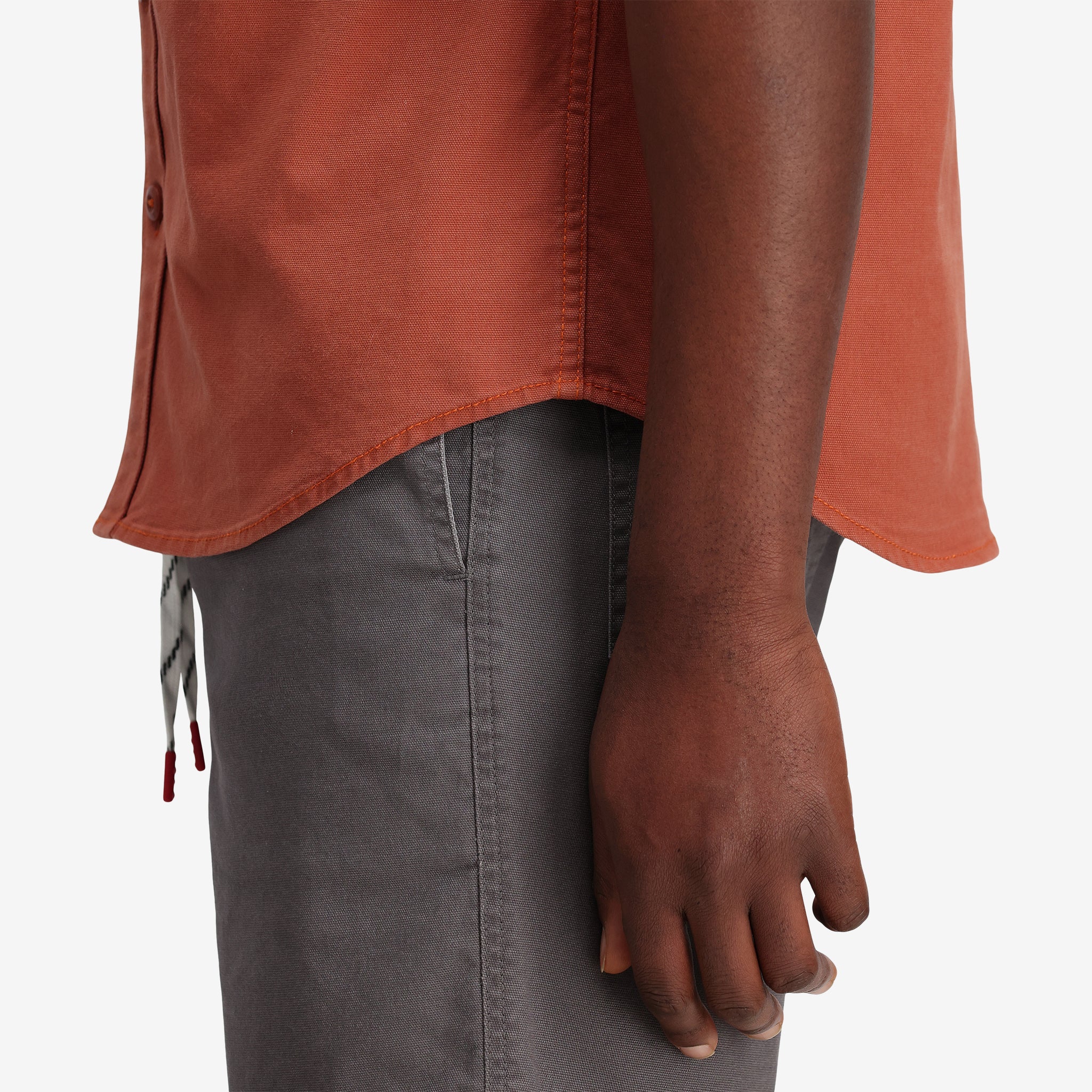 General shot of Topo Designs Men's Short Sleeve Dirt Shirt in "Brick" orange closeup.