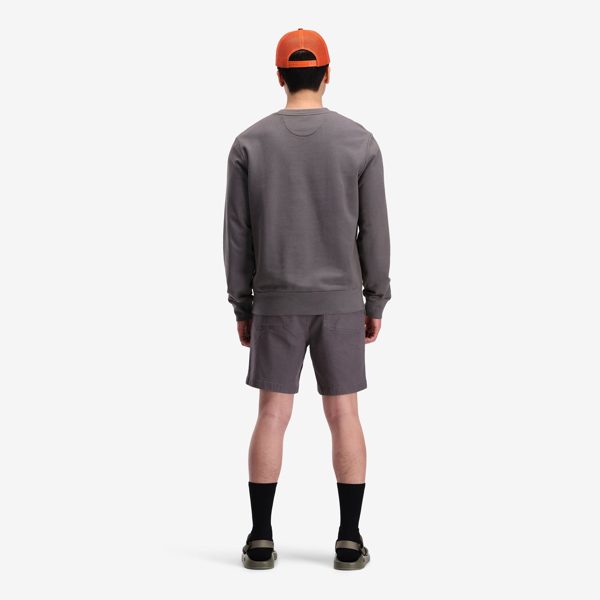 General back model shot of Topo Designs Men's Dirt Crew sweatshirt in 100% organic cotton in "charcoal" grey.