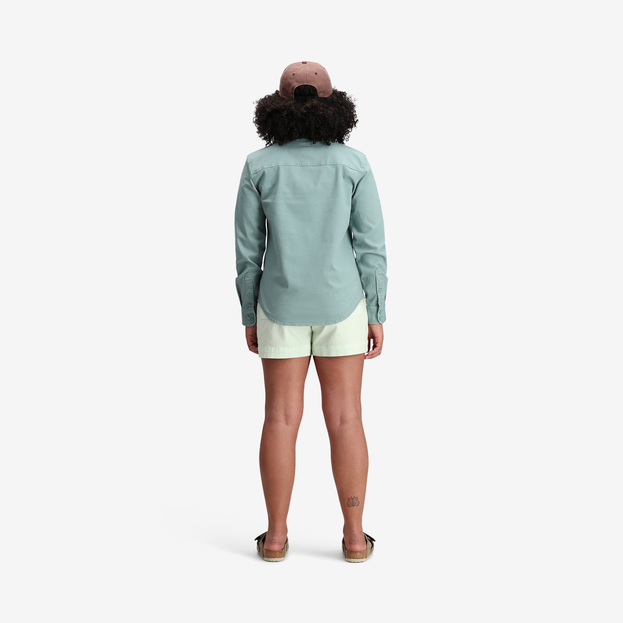 Model shot of Topo Designs Women's Dirt Shirt in "Sage" Green Blue.