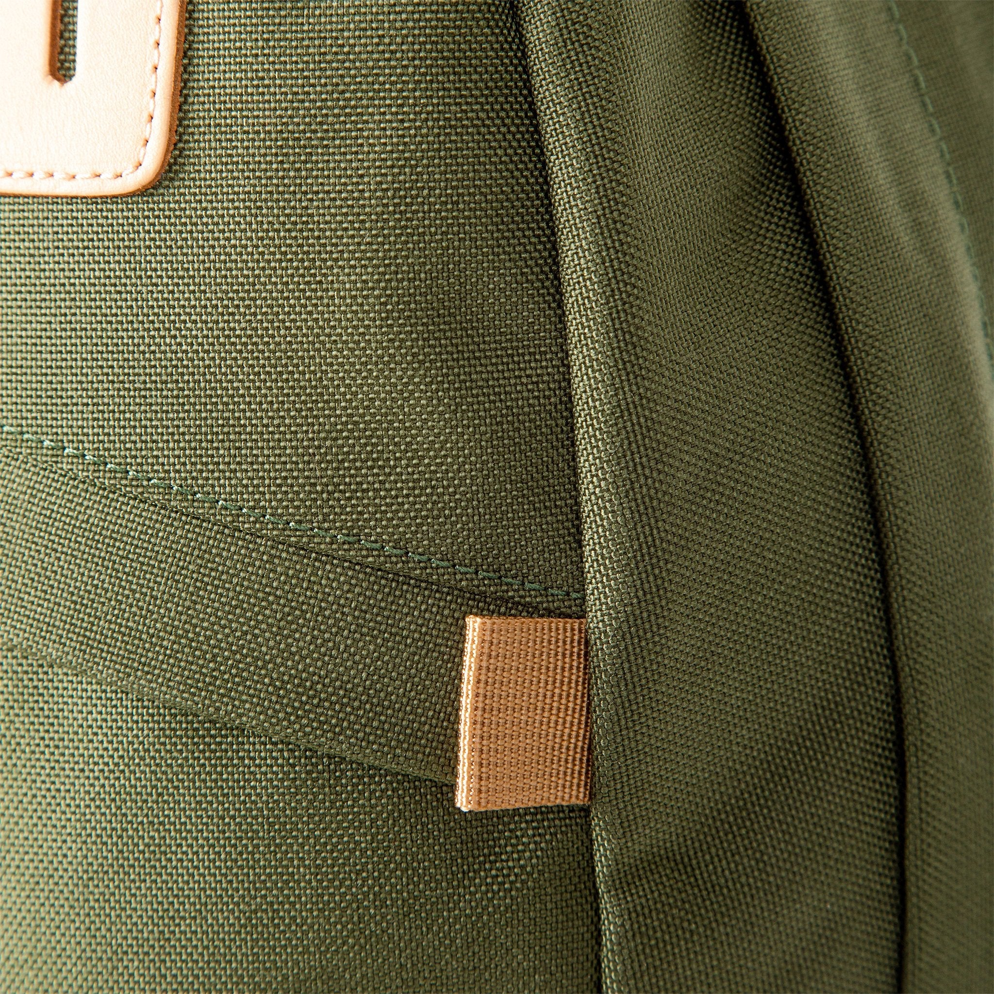 Fabric detail on Topo Designs Daypack Classic 100% recycled nylon laptop backpack for work or school in Olive green.