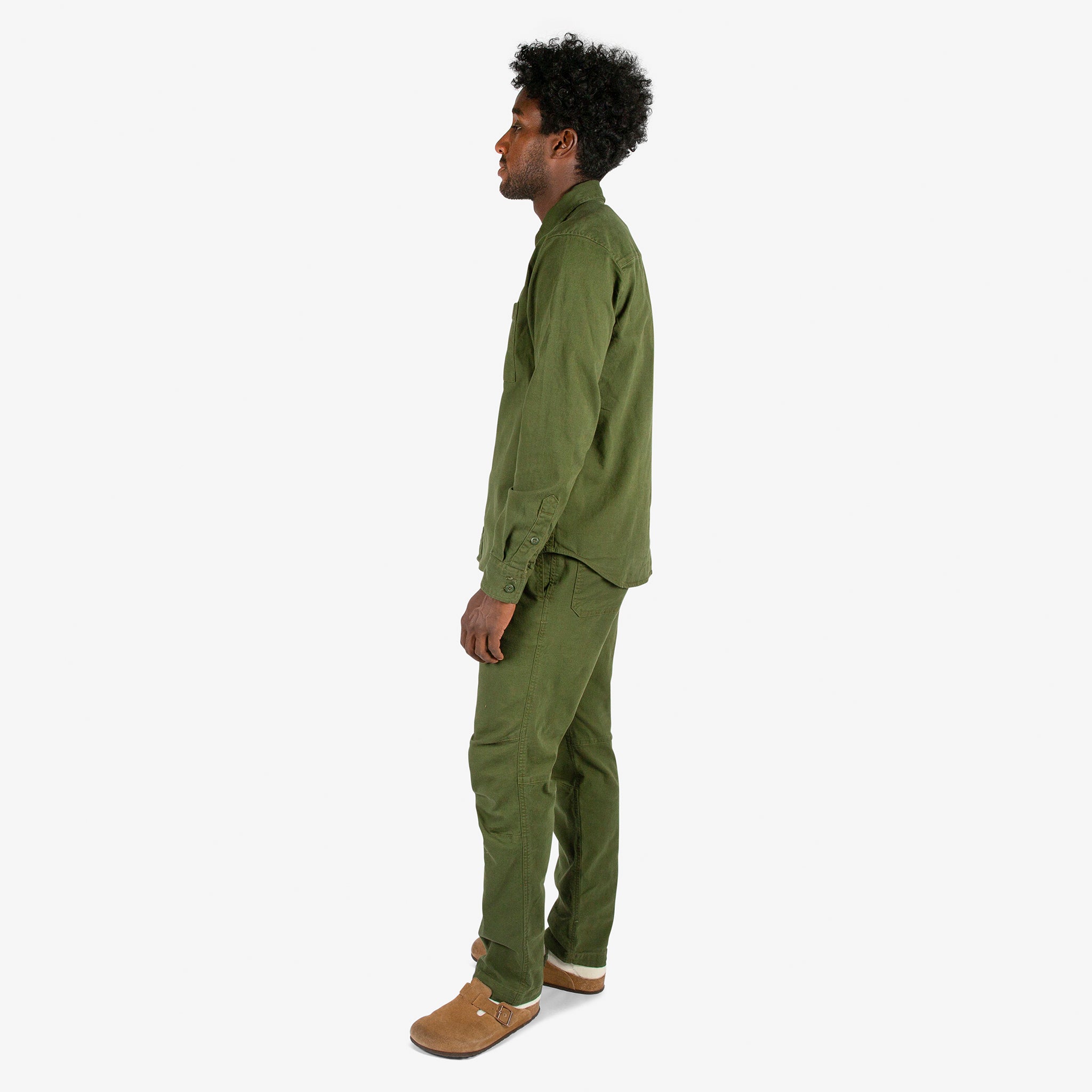 Full side model shot of Topo Designs Men's Dirt Shirt & Pants in "Olive".