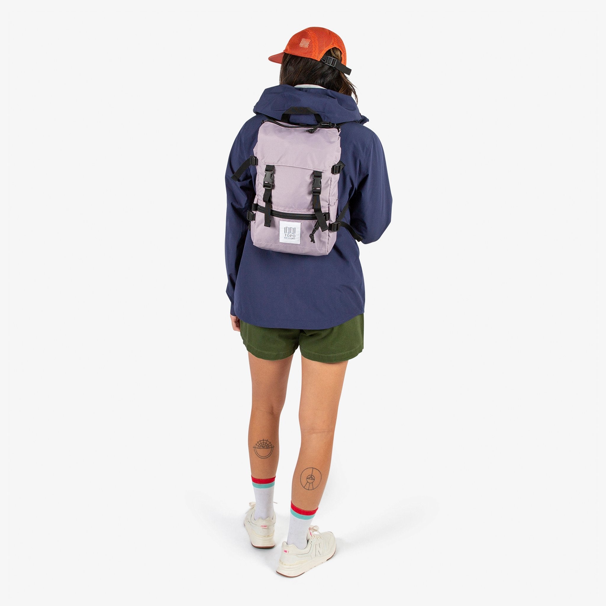 Topo Designs Rover Pack Mini backpack in Light Purple worn by model with backpack straps.