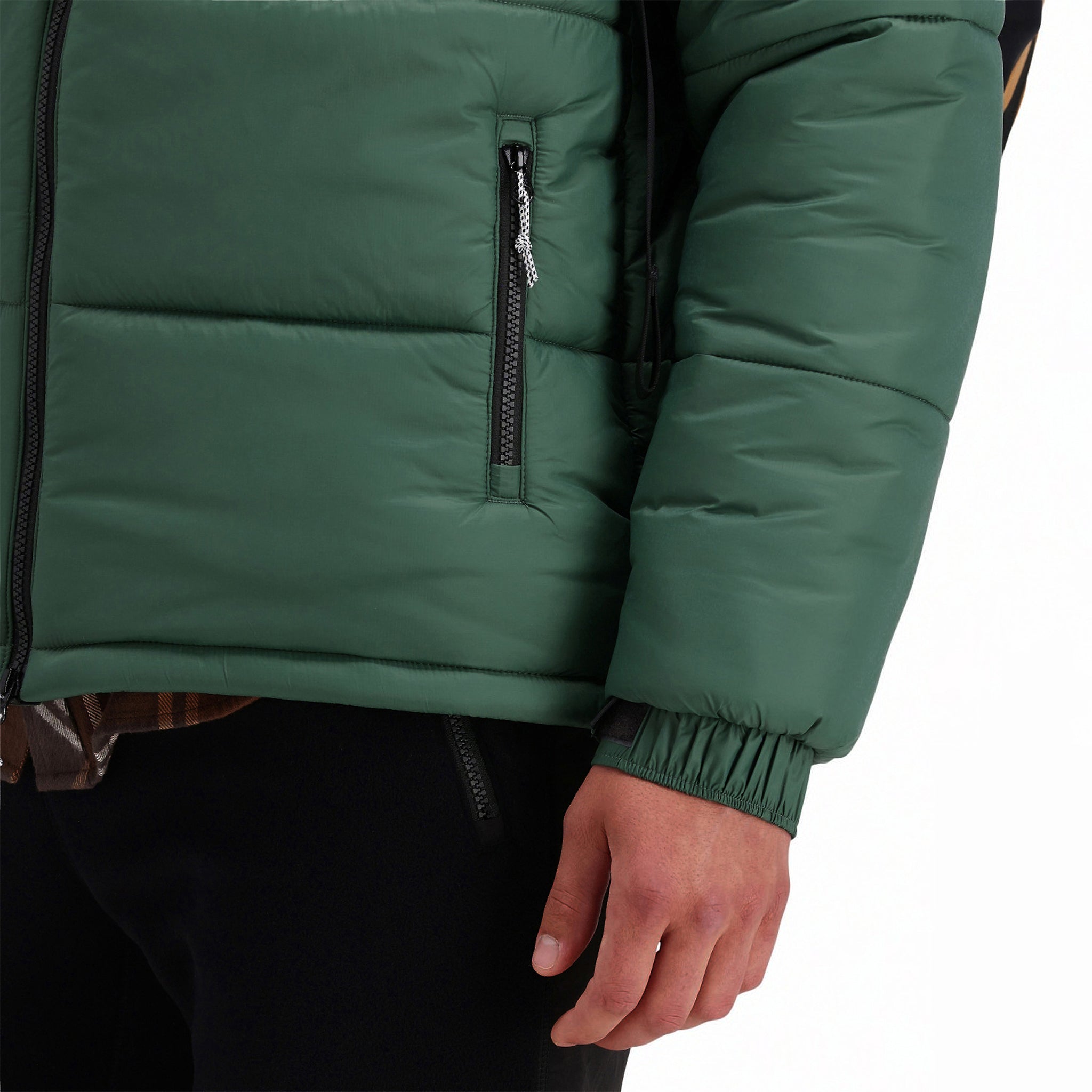 Front model shot of zipper hand pockets and adjustable velcro cuff on Topo Designs Men's Puffer recycled insulated Jacket in "forest" green.