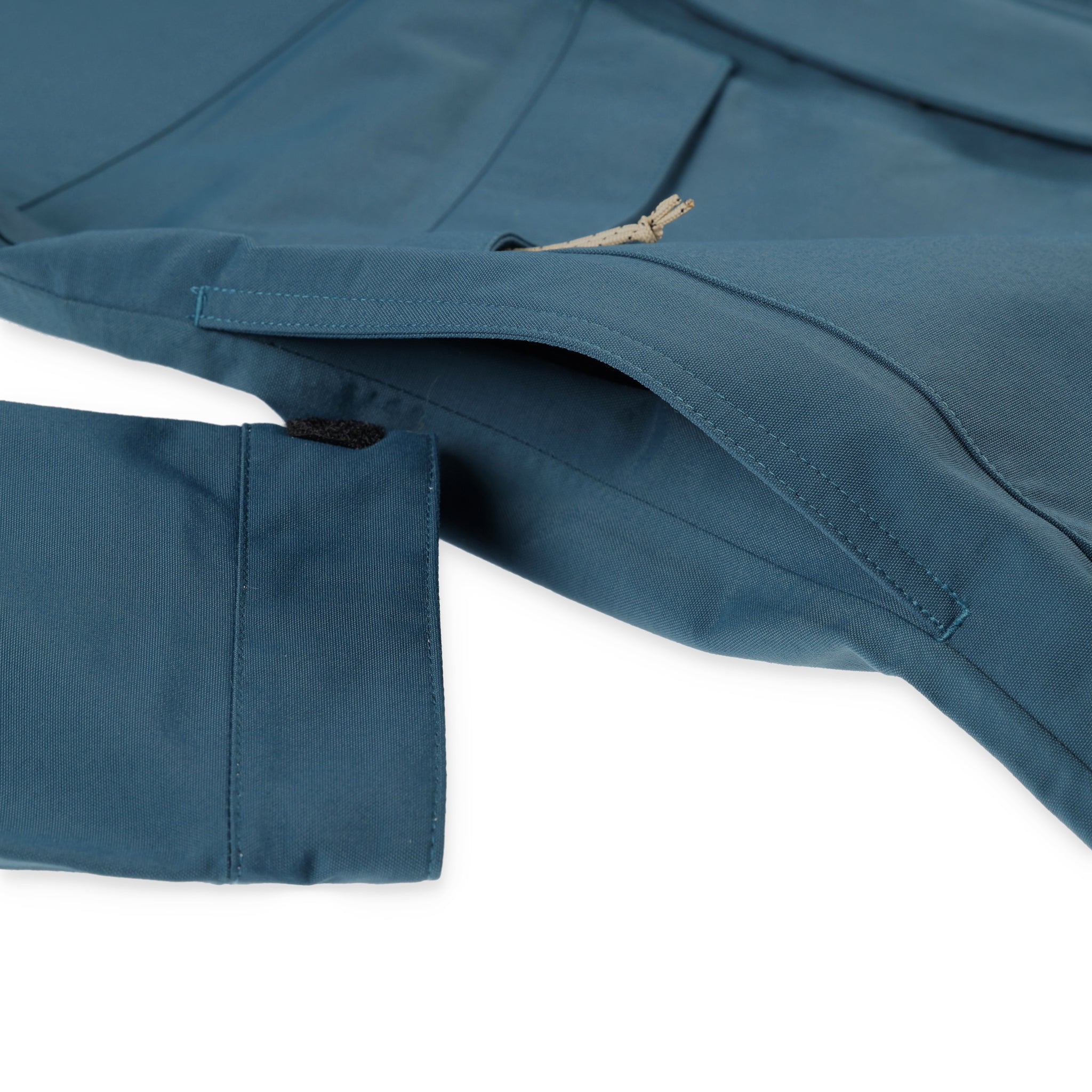 General detail shot of hand pockets on Topo Designs Men's Mountain Parka waterproof shell jacket in "Pond Blue"