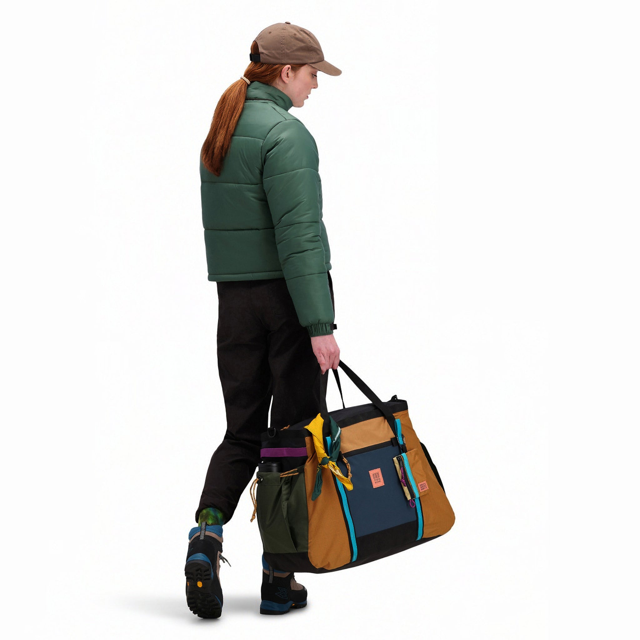 Back model shot of Topo Designs Women's Puffer recycled insulated Jacket in "Forest" green.