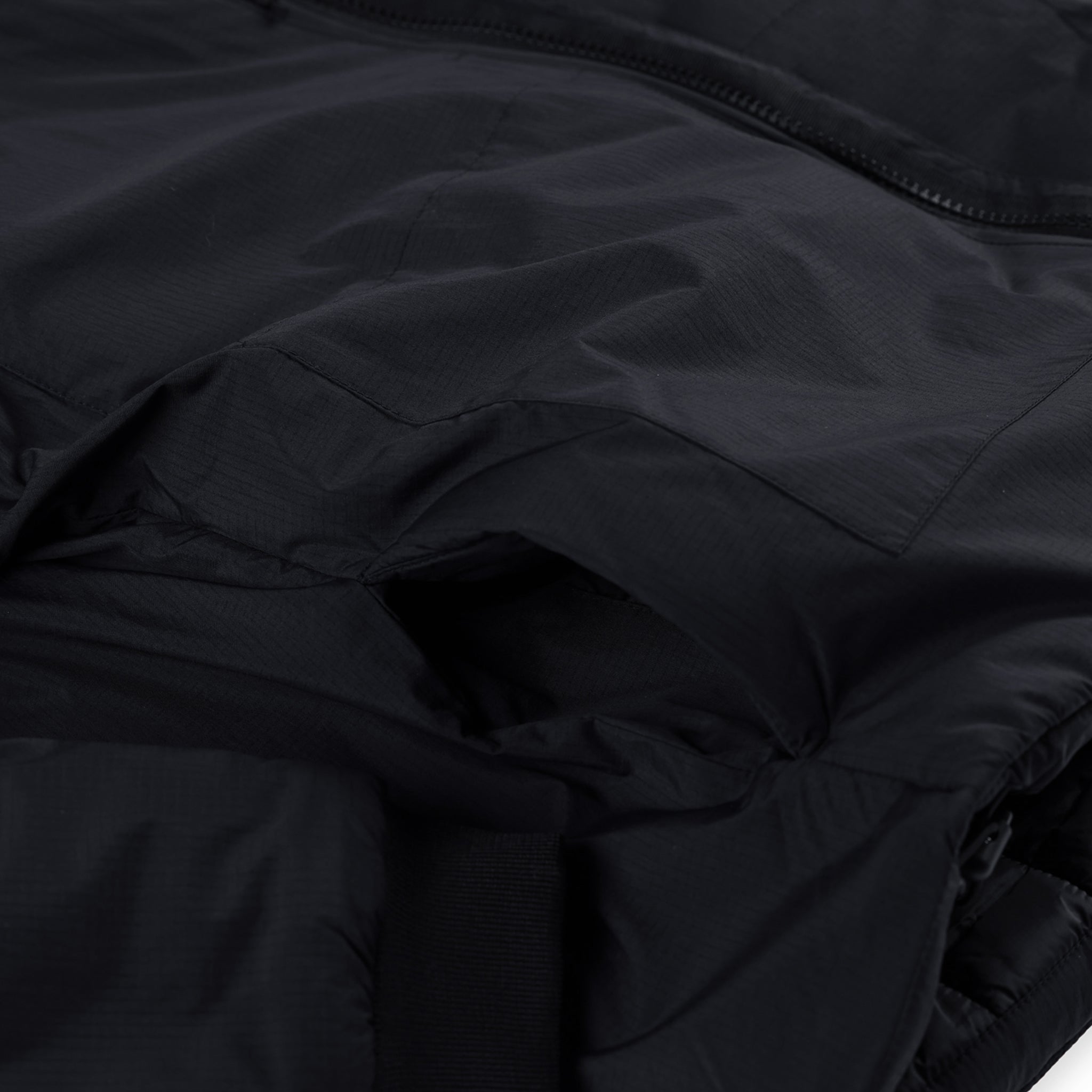 General detail shot of hand pockets on Topo Designs Women's Puffer Primaloft insulated Hoodie jacket in "black"