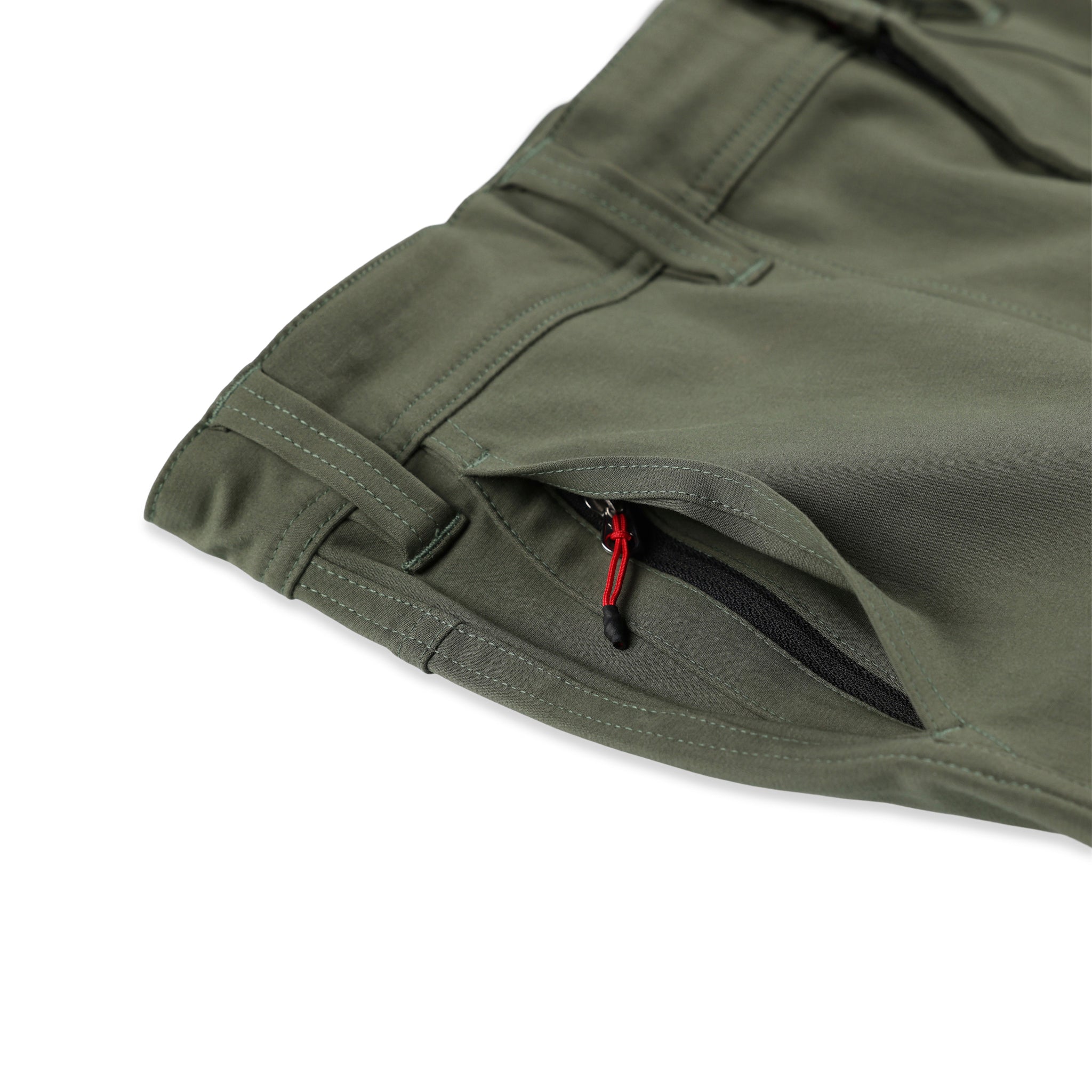 Hidden front zipper pocket on Topo Designs Men's Global Pants lightweight cotton nylon travel pants in olive green.